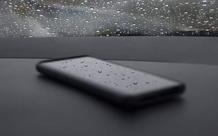 A phone has water droplets to demonstrate water resistance
